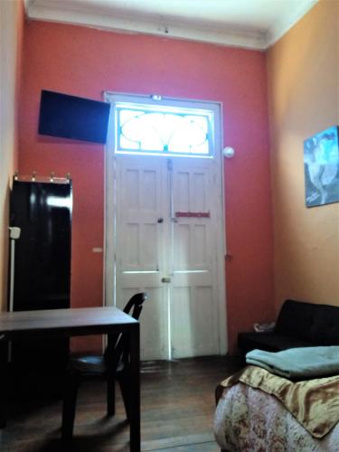 a room with a door with a window and a table at Casona Moya in Arequipa