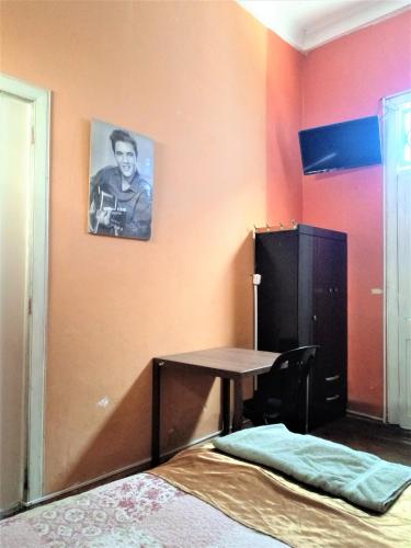a room with a table and a picture on the wall at Casona Moya in Arequipa