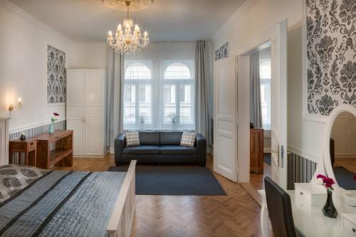 a living room with a bed and a couch at Veleslavinova 4 - Old Town Apartment in Prague