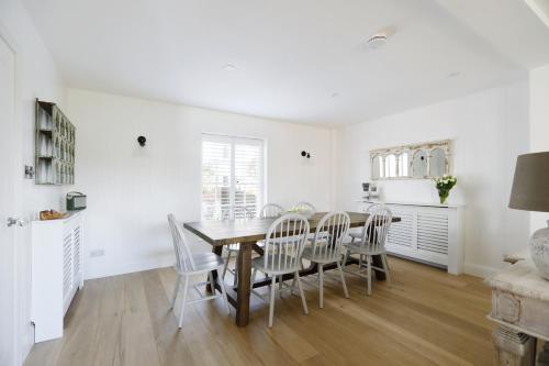 a dining room with a table and chairs at Bennet House in Arundel