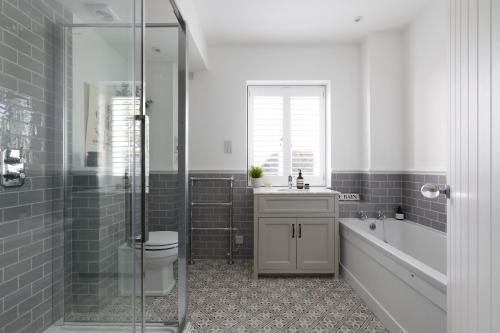 a bathroom with a toilet and a sink and a shower at Bennet House in Arundel