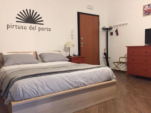 a bedroom with a large bed and a dresser at palermo casa vacanze in Palermo