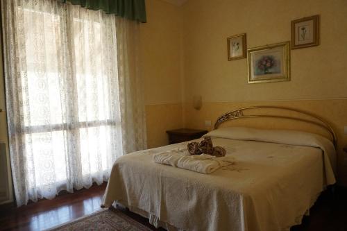 a bedroom with a bed with a teddy bear on it at B&B Principessa Isabella in Santa Luria