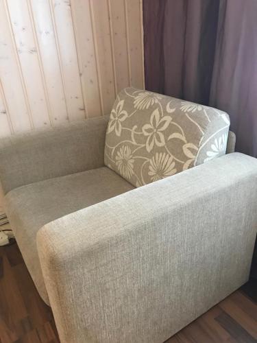 a couch with a pillow on top of it at E-City B&B in Tornio
