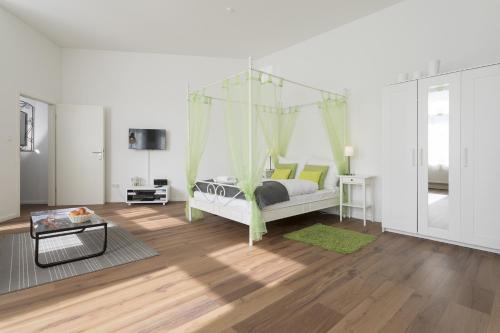 a bedroom with a bed with a canopy at Studio Apartment Niemetzstr 51 in Berlin
