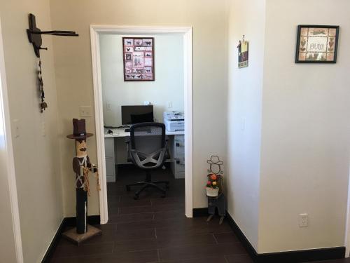 an office with a door leading into a room with a desk at Mountain Star Lodge in Austin