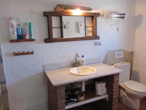 a bathroom with a sink and a toilet at Cuevas el Balcón de Orce in Orce