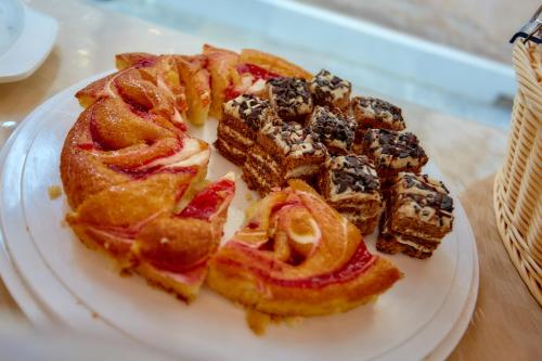 a white plate of desserts on a table at Hotel Riviera dei Dogi in Mira