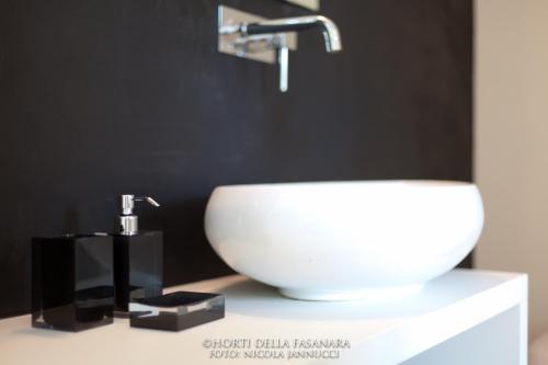 a white sink on a counter in a bathroom at Horti Della Fasanara in Ferrara