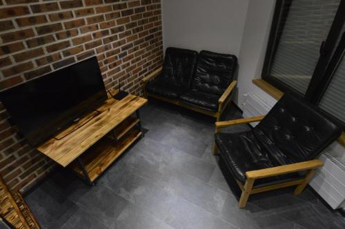 a living room with a table and a chair at Air Loft Apartment in Kyiv