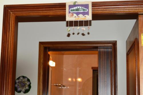a mirror with a sign hanging over it at Matosinho's Palace in Matosinhos
