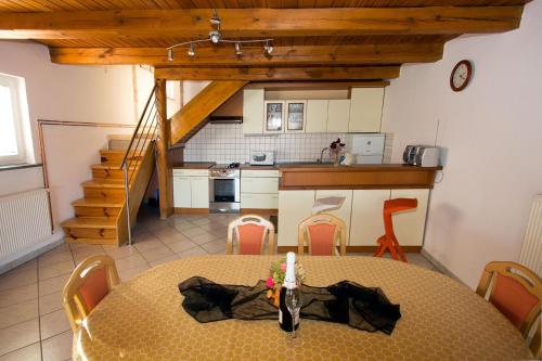 a kitchen and dining room with a table and chairs at Holiday Home Janko in Bogojina