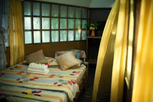a bedroom with a bed with a candle on it at Natura Vista in Panglao