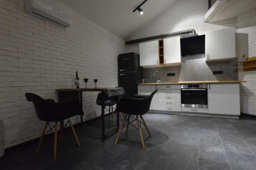 a kitchen with a counter and chairs in it at Air Loft Apartment in Kyiv