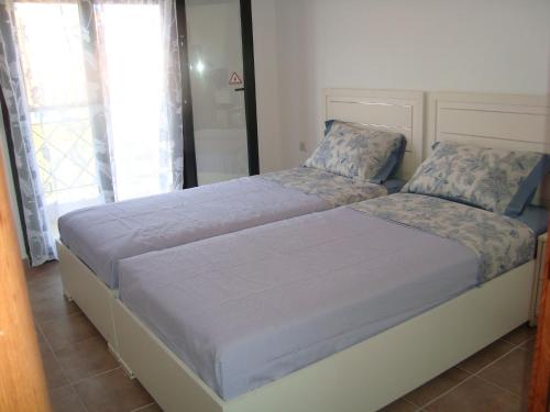 a bedroom with a large bed with blue sheets at Apartment for Family in Kriopigi