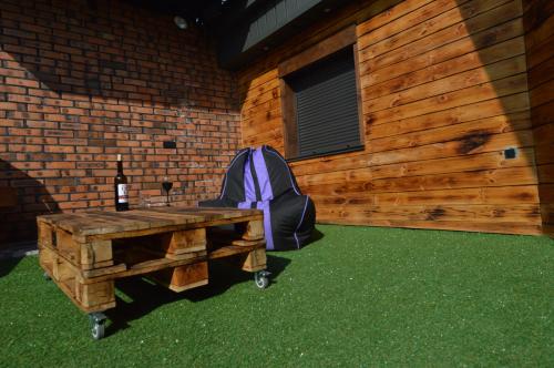 a picnic table with a backpack and a bottle of wine at Air Loft Apartment in Kyiv