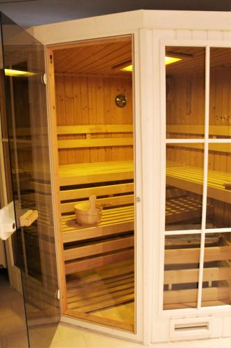 a cabinet with a glass door in a kitchen at Hotel-Restaurant Nordlicht in Kappeln