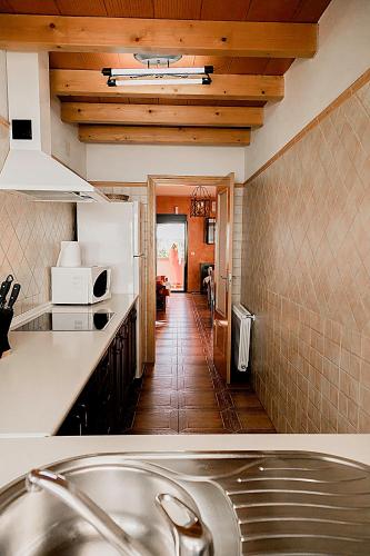 a kitchen with a sink and a counter top at Apartamentos Los Panchos in Ruidera