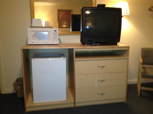 a desk with a microwave and a tv on it at Greencastle Inn in Greencastle