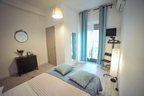 a bedroom with a bed and a dresser and a mirror at Salerno Inn B&B in Salerno