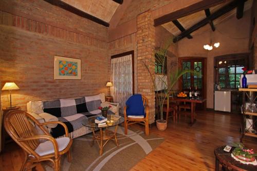 a living room with a couch and a table and chairs at Casa Glebinias in Chacras de Coria