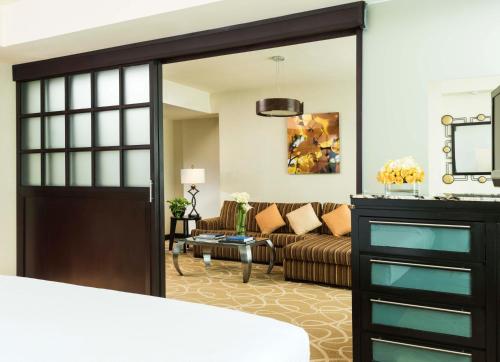 a living room with a couch and a sliding glass door at Hotel Marquis Reforma in Mexico City