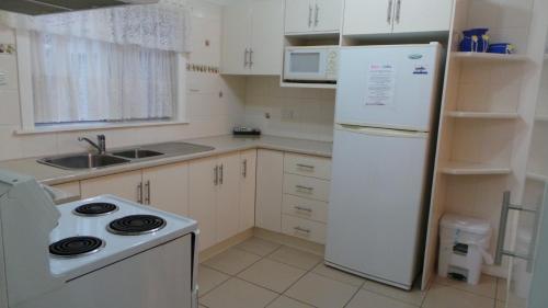a kitchen with a white refrigerator and a stove at Casa Bella in Tamworth