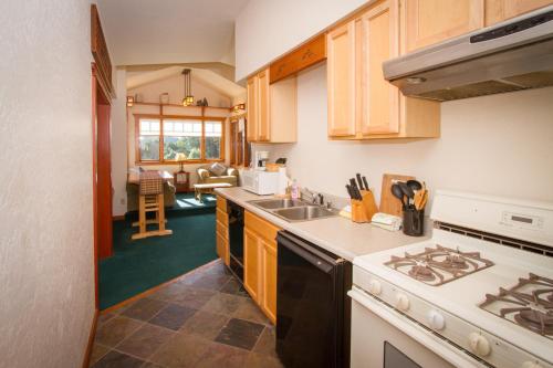 a kitchen with a sink and a stove top oven at Mendocino View East in Mendocino