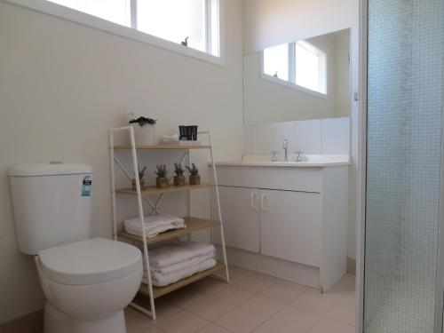 a bathroom with a toilet and a sink and a shower at 3107 Estate in Irymple
