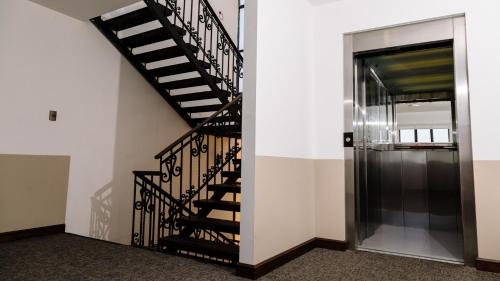 a black spiral staircase in a building with a door at Hotel Villa del Carmen in Arequipa