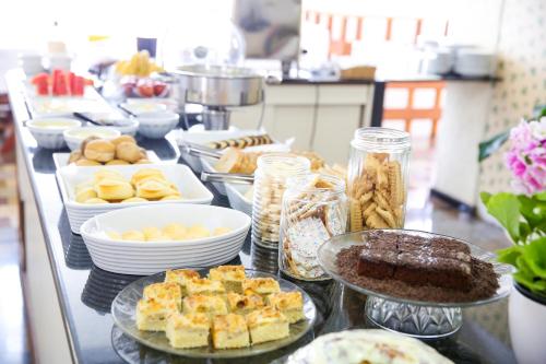 a buffet of food on a counter in a kitchen at Hotel Mos São José in São José