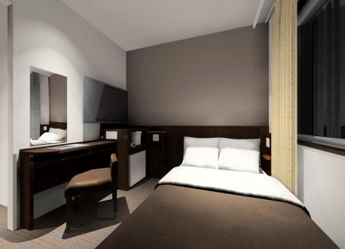 a bedroom with a bed and a desk and a mirror at Urbain Tokyo Ueno Kitasenju in Tokyo