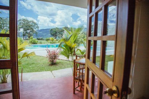 a door leading to a patio with a view of a pool at Maloca Inn in Sauce