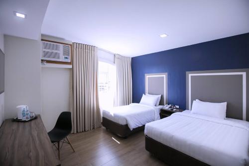 Säng eller sängar i ett rum på S Hotel & Residences
