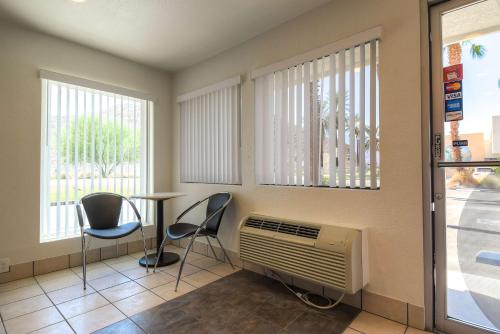 a waiting room with chairs and a heater and a table at Motel 6-Rancho Mirage, CA - Palm Springs in Rancho Mirage