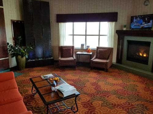 a living room with a couch and a fireplace at Rock Island Inn & Suites Marshalltown in Marshalltown