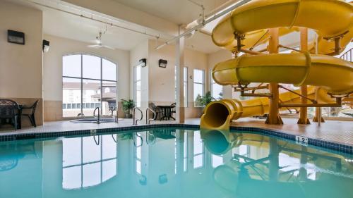 a pool with a water slide in a building at Best Western Rocky Mountain House in Rocky Mountain House
