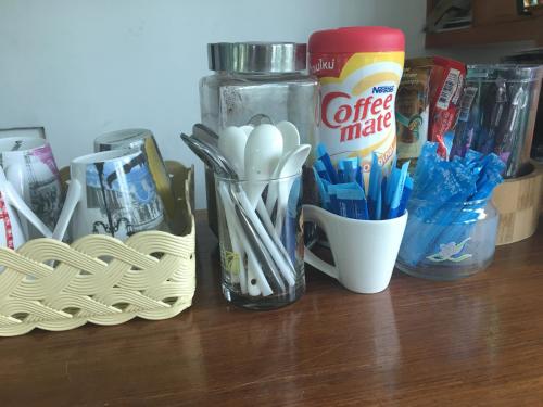 a counter with toothbrushes and a cup of coffee melts at The Creek Villa in Loei