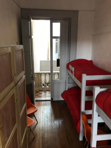 a room with two bunk beds and a window at Student’s Hostel in Montevideo