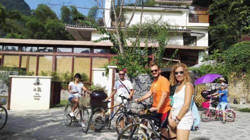 a group of people riding bikes on a street at The Apsara Lodge-Airport or TS Free pick-up over 3 nights in Yangshuo