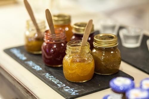 a group of jars of honey on a black tray at Hotel Luze El Toro in Berrioplano