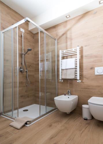 a bathroom with a shower and a toilet and a sink at Relais Dei Mandorli in Bergamo