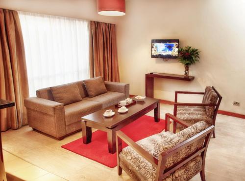 a living room with a couch and a table at The Zehneria Hotel in Nairobi