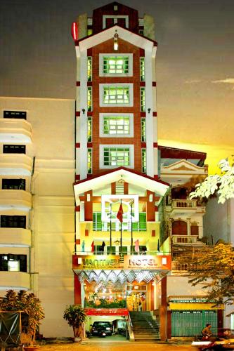 a tall building with a store in front of it at Van Mieu Hotel in Hanoi