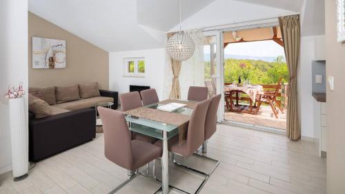 a living room with a table and a couch at Pavao Apartments in Vrboska