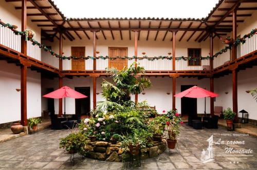 a courtyard with umbrellas and plants in a building at La Casona Monsante in Chachapoyas