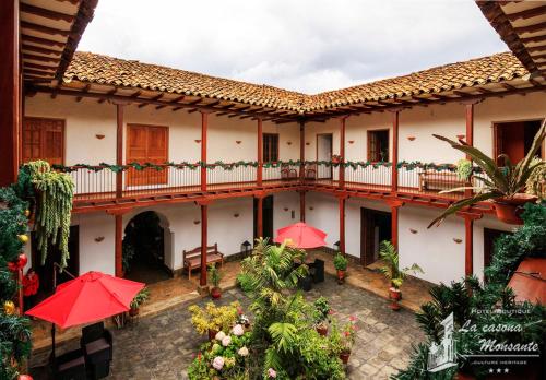 a courtyard of a building with red umbrellas at La Casona Monsante in Chachapoyas