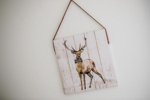 a picture of a deer hanging on a wall at Apartment 20 Inchmarlo in Banchory