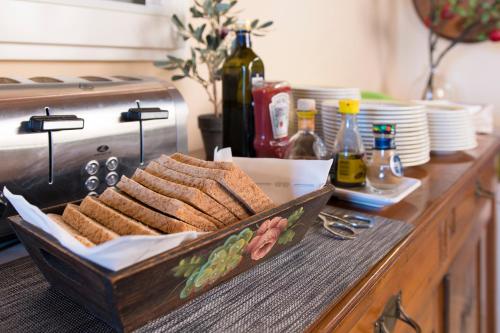 a tray of sandwiches on a counter with plates and a stove at Palazzo Pacini in Colle Val D'Elsa