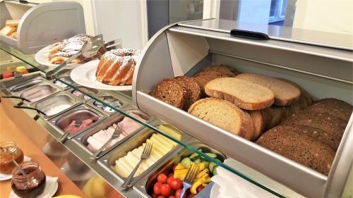 a refrigerator filled with lots of different types of bread at Hotel U dvou zlatých klíčů in Prague